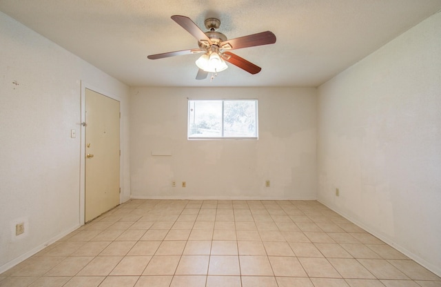 tiled empty room with a textured ceiling and ceiling fan