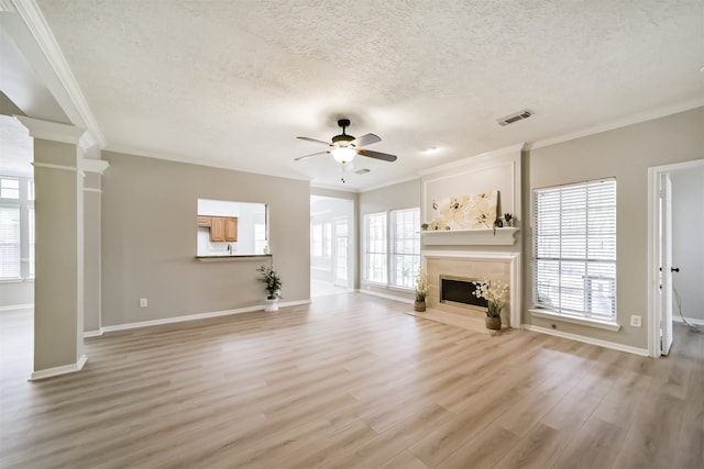 unfurnished living room with hardwood / wood-style floors, a textured ceiling, ceiling fan, and ornamental molding