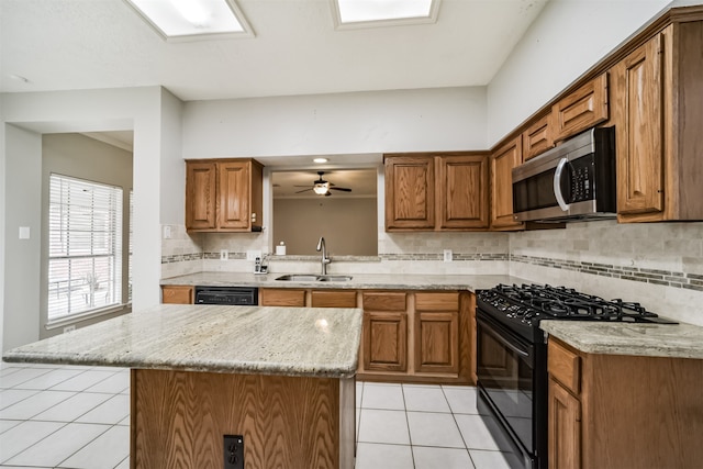 kitchen featuring black appliances, sink, decorative backsplash, light stone countertops, and light tile patterned floors