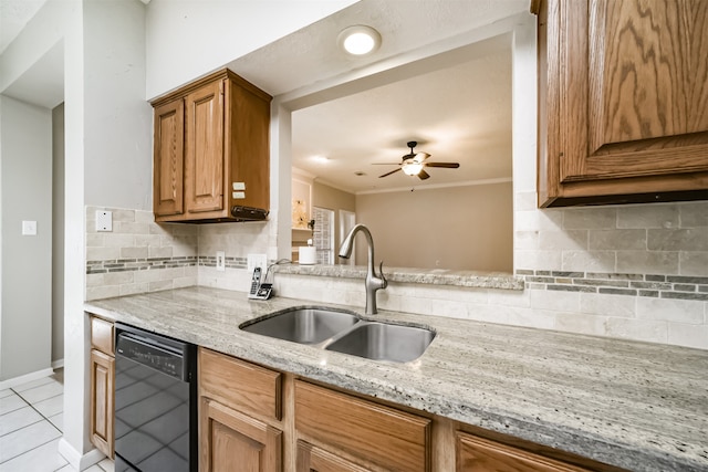 kitchen with dishwasher, light stone counters, sink, and tasteful backsplash