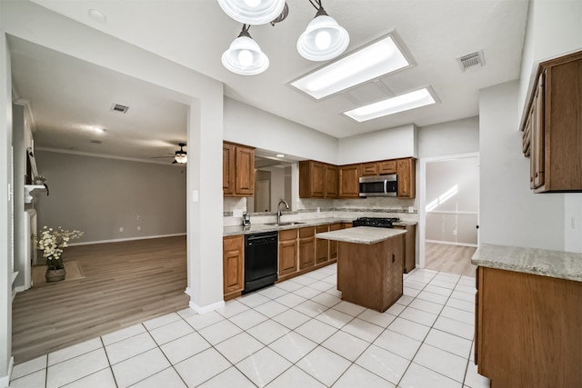 kitchen with a center island, sink, pendant lighting, light hardwood / wood-style floors, and black appliances