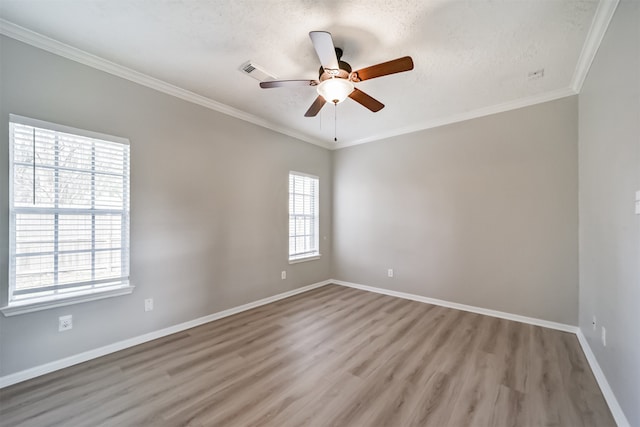 empty room with ceiling fan, light hardwood / wood-style floors, ornamental molding, and a textured ceiling