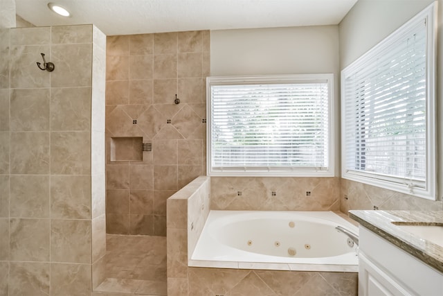 bathroom featuring vanity and independent shower and bath