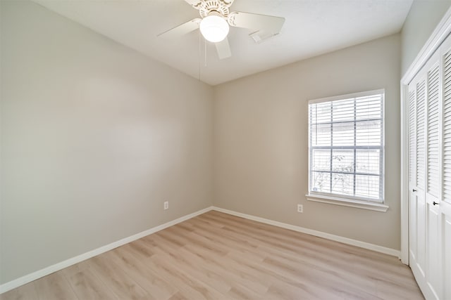 unfurnished bedroom featuring light wood-type flooring, a closet, and ceiling fan