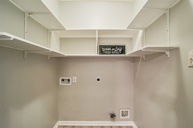 laundry room featuring hookup for an electric dryer, hookup for a washing machine, and hardwood / wood-style flooring