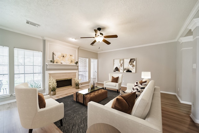 living room featuring a textured ceiling, hardwood / wood-style flooring, and a wealth of natural light