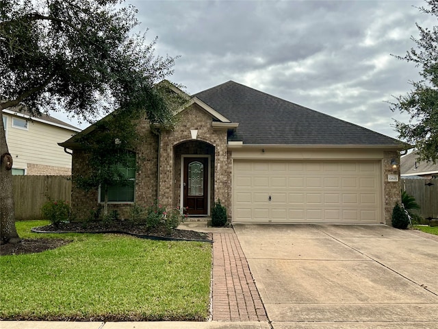 view of front of home with a garage and a front lawn