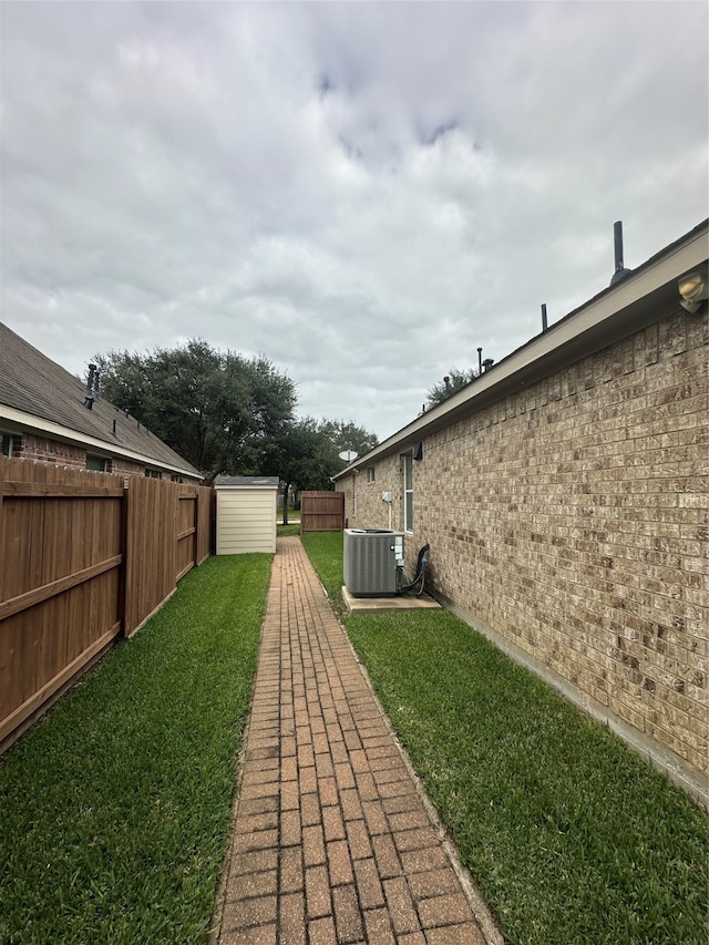 view of yard with cooling unit and a shed