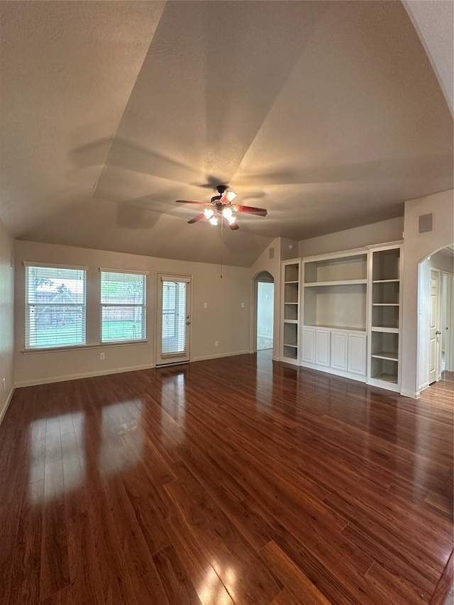 unfurnished living room with ceiling fan, dark hardwood / wood-style flooring, and vaulted ceiling