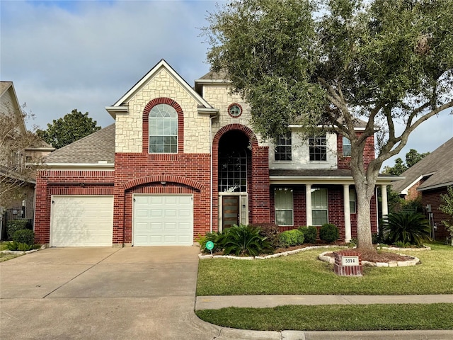 view of front of property featuring a front yard and a garage