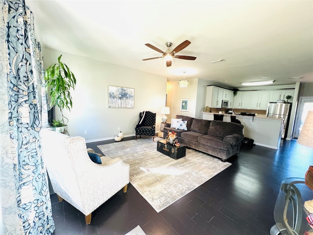 living room with ceiling fan and dark hardwood / wood-style flooring