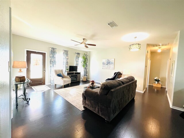 living room with ceiling fan and dark hardwood / wood-style flooring