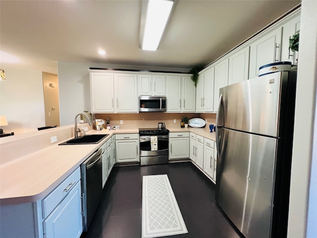 kitchen with kitchen peninsula, stainless steel appliances, white cabinets, and sink