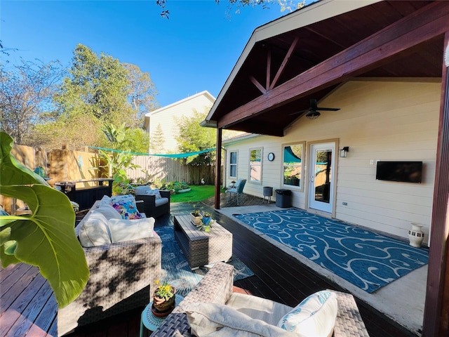 view of patio with outdoor lounge area, ceiling fan, and a deck