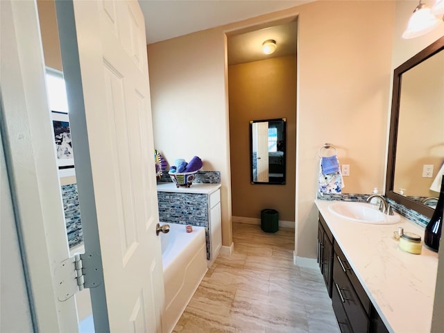 bathroom with vanity and a tub