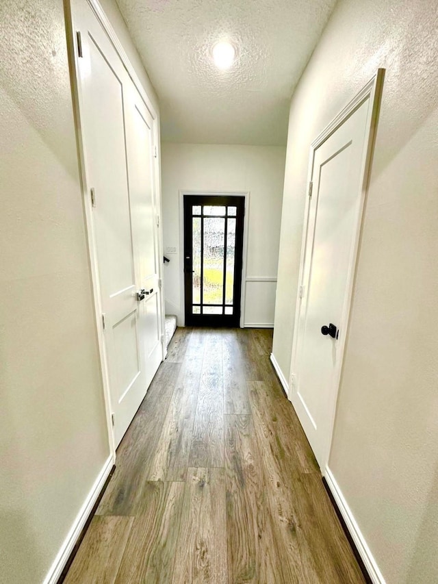 entryway featuring a textured ceiling and hardwood / wood-style floors