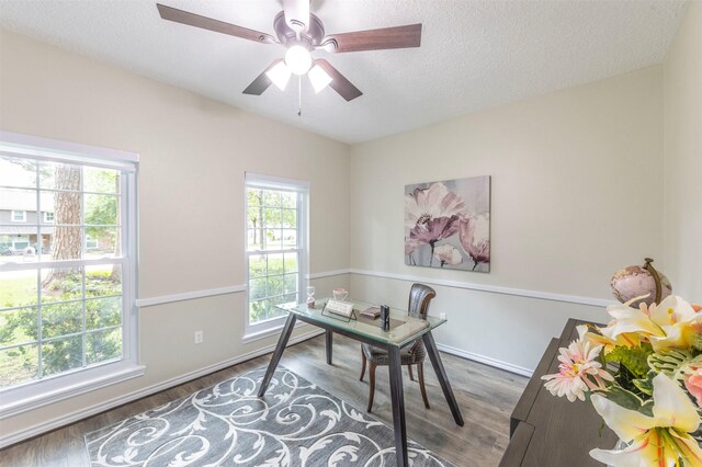 office space with ceiling fan, dark wood-type flooring, and a textured ceiling