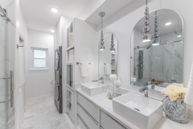 bathroom with a shower with door and vanity