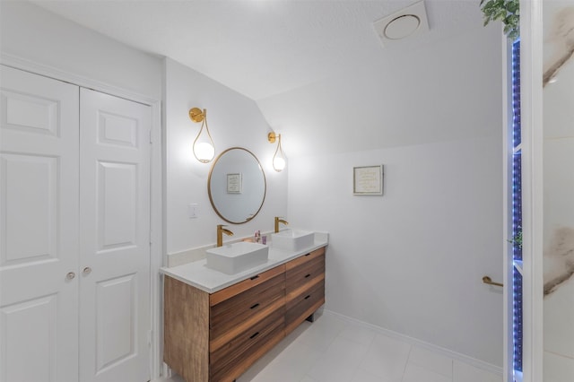 bathroom with vanity and vaulted ceiling