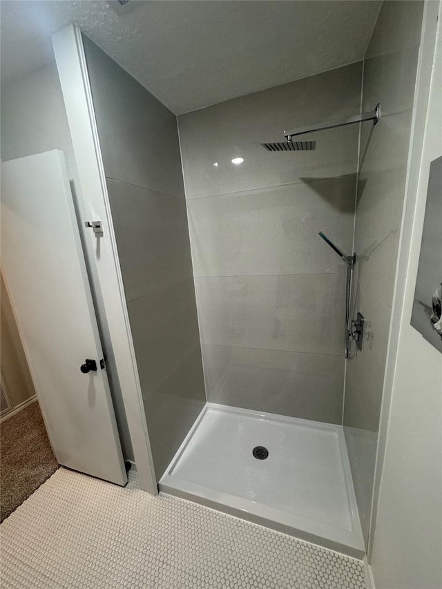 bathroom featuring tile patterned flooring and walk in shower