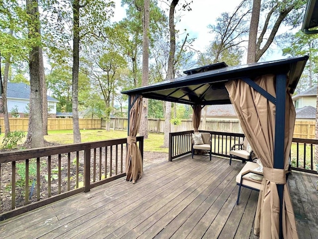 wooden deck featuring a gazebo and a yard