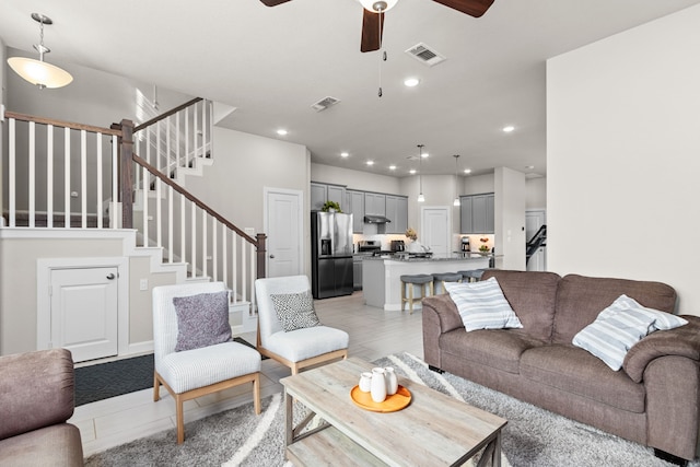 living room featuring ceiling fan and light hardwood / wood-style floors