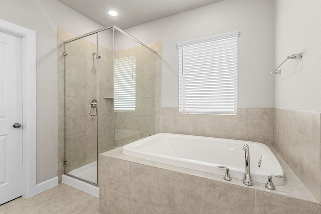 bathroom with tile patterned floors and independent shower and bath