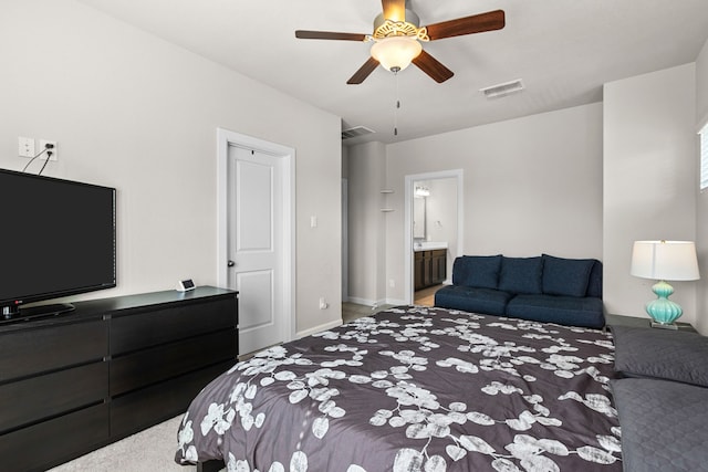 bedroom with carpet flooring, ceiling fan, and ensuite bath