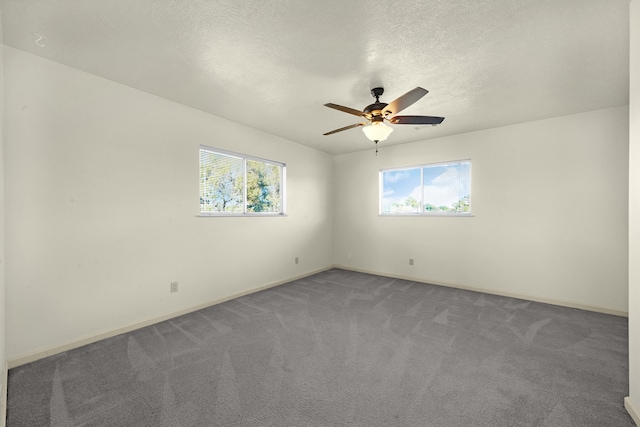 carpeted empty room with a textured ceiling, ceiling fan, and a healthy amount of sunlight