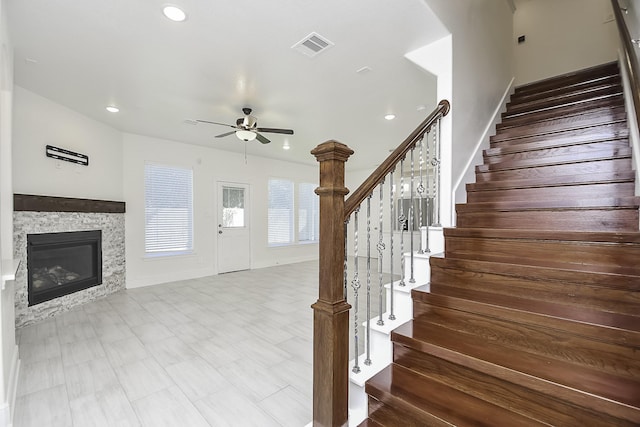 13754 Lynx Dr, Houston, TX 77014 - stairway with a ceiling fan, recessed lighting, and a stone fireplace