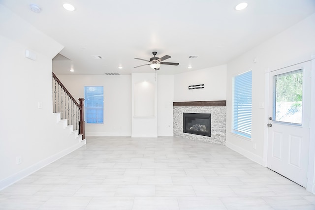 unfurnished living room featuring ceiling fan