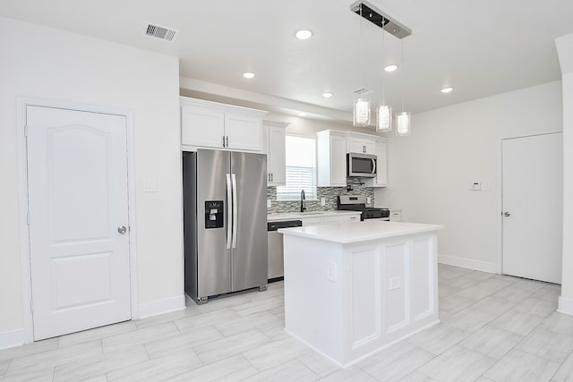 kitchen with white cabinetry, sink, a center island, hanging light fixtures, and appliances with stainless steel finishes