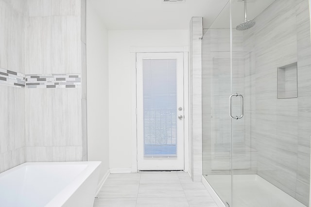 bathroom with separate shower and tub