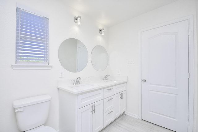 13754 Lynx Dr, Houston, TX 77014 - full bathroom featuring double vanity, toilet, and baseboards