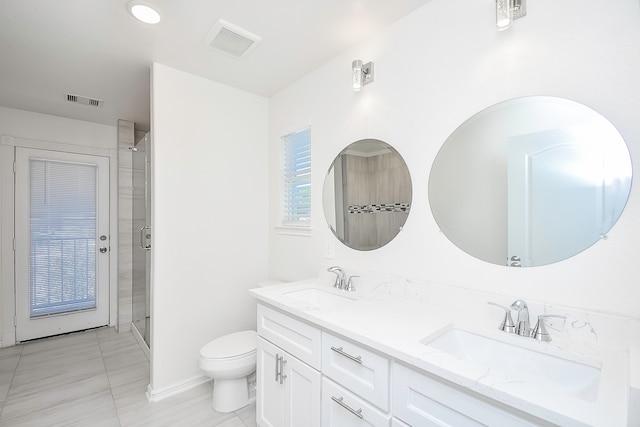 bathroom with tile patterned floors, toilet, vanity, and walk in shower