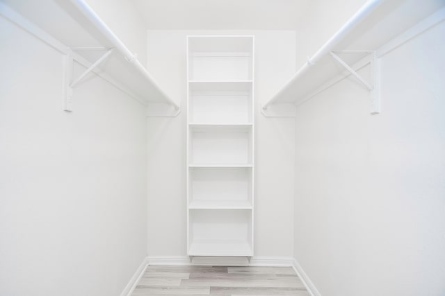 spacious closet with light hardwood / wood-style flooring