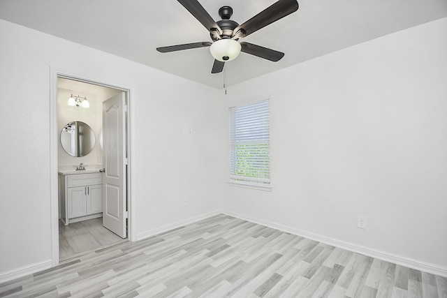 13754 Lynx Dr, Houston, TX 77014 - unfurnished bedroom featuring light wood finished floors, baseboards, a sink, and a ceiling fan