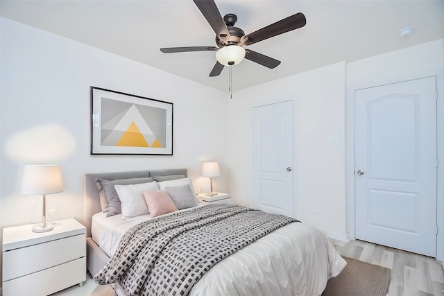 bedroom with light hardwood / wood-style floors and ceiling fan