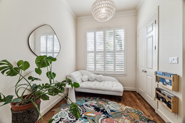 sitting room with a chandelier, dark hardwood / wood-style floors, and ornamental molding