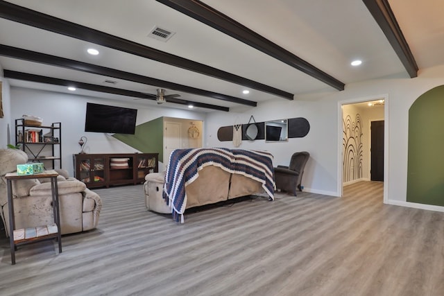 bedroom featuring beamed ceiling and light hardwood / wood-style floors