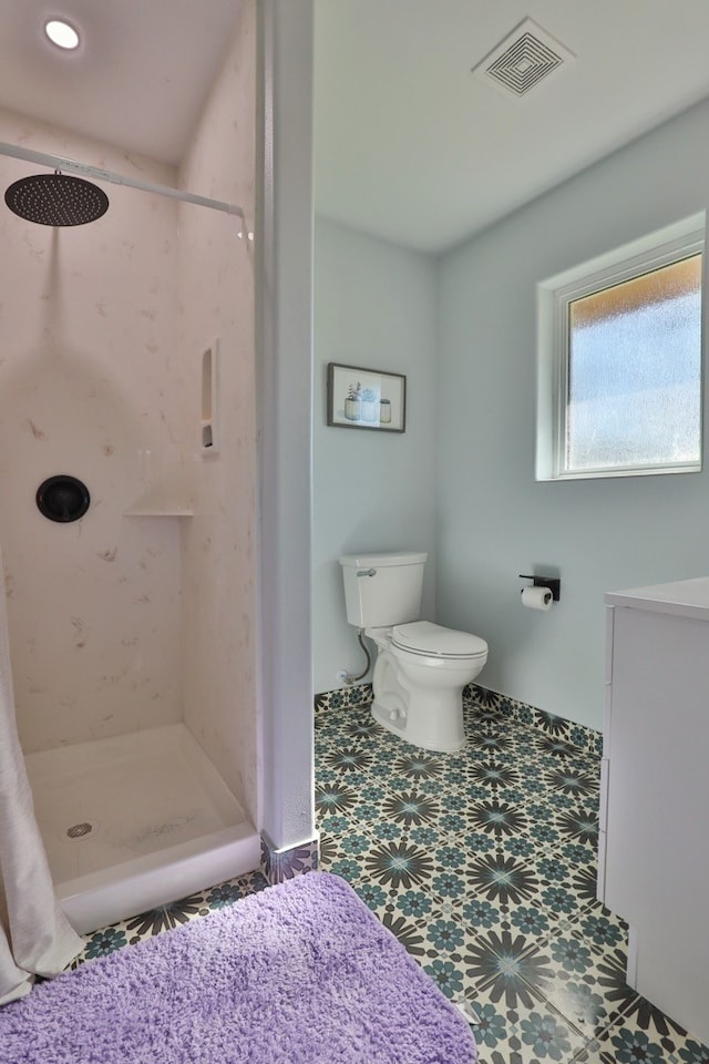 bathroom with toilet and walk in shower