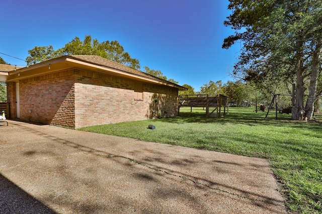 view of side of property with a lawn