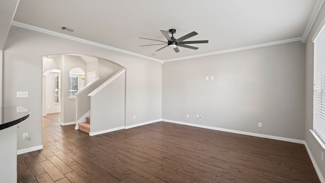 unfurnished room featuring ornamental molding, ceiling fan, and dark wood-type flooring