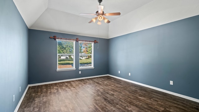 empty room featuring hardwood / wood-style flooring, vaulted ceiling, and ceiling fan