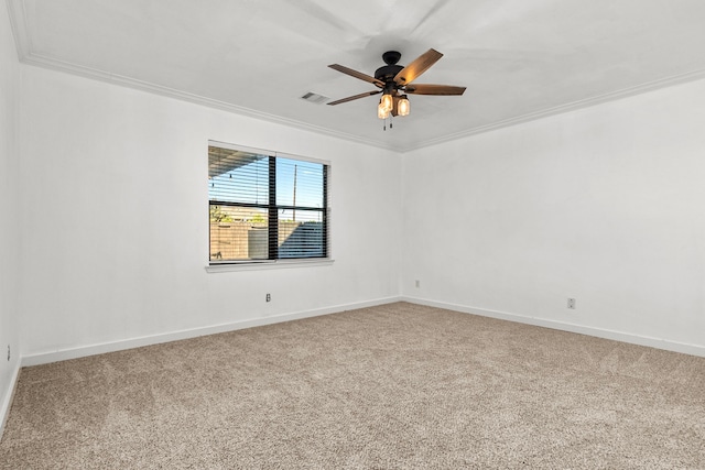 empty room with ceiling fan, ornamental molding, and carpet floors