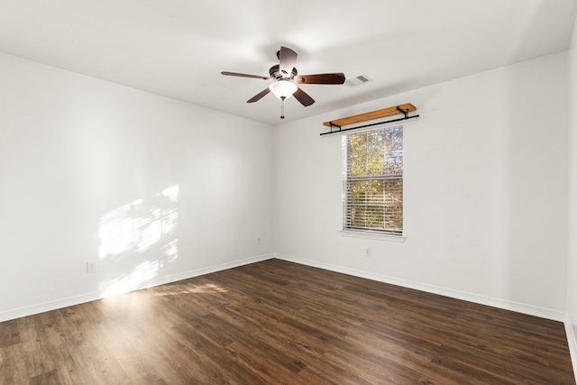 spare room with ceiling fan and dark hardwood / wood-style flooring