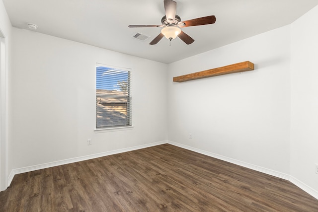 empty room with ceiling fan and dark wood-type flooring