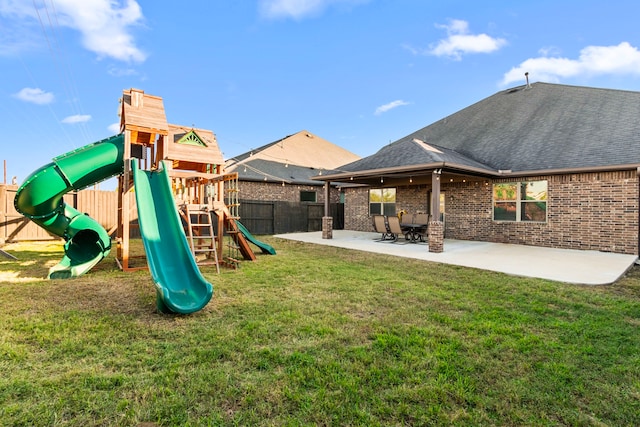 view of playground featuring a yard and a patio