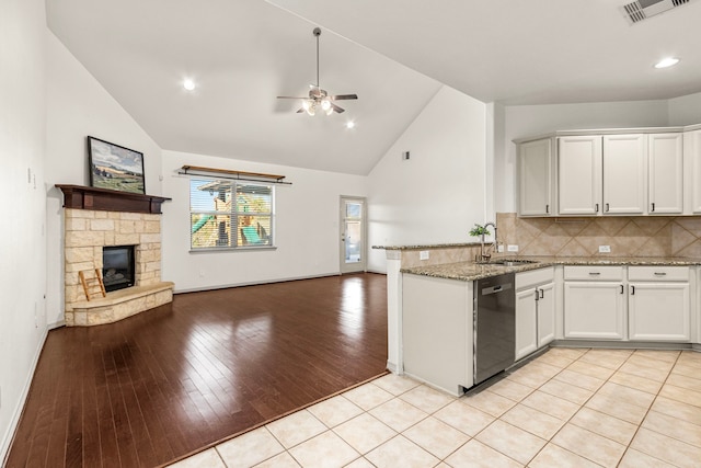 kitchen featuring white cabinetry, dishwasher, ceiling fan, sink, and light wood-type flooring