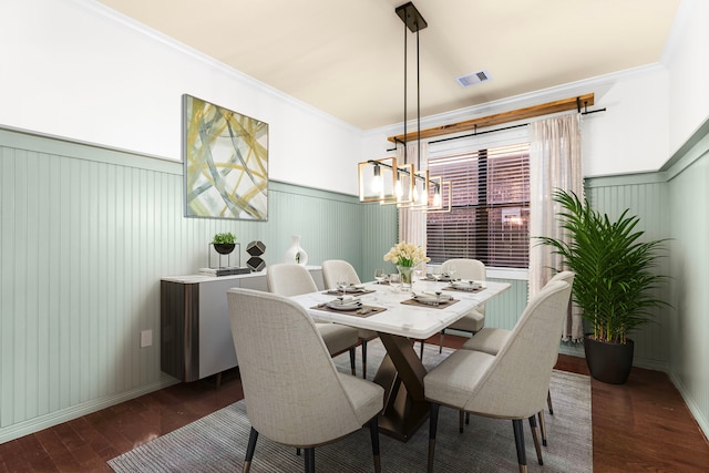 dining area featuring crown molding and dark hardwood / wood-style floors